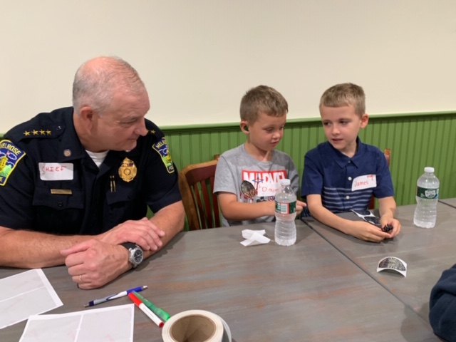 Photo of Police Chief Michael Lyle having pizza with children