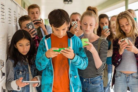 Teenagers looking at smartphones