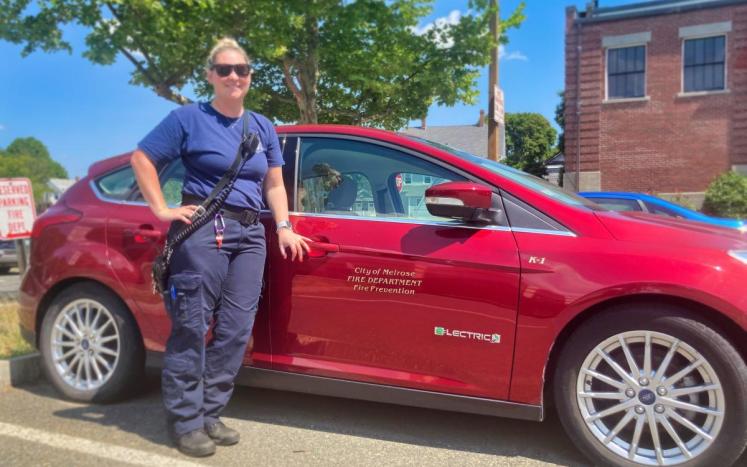 Christin Harris with Fire Department's Electric Vehicle